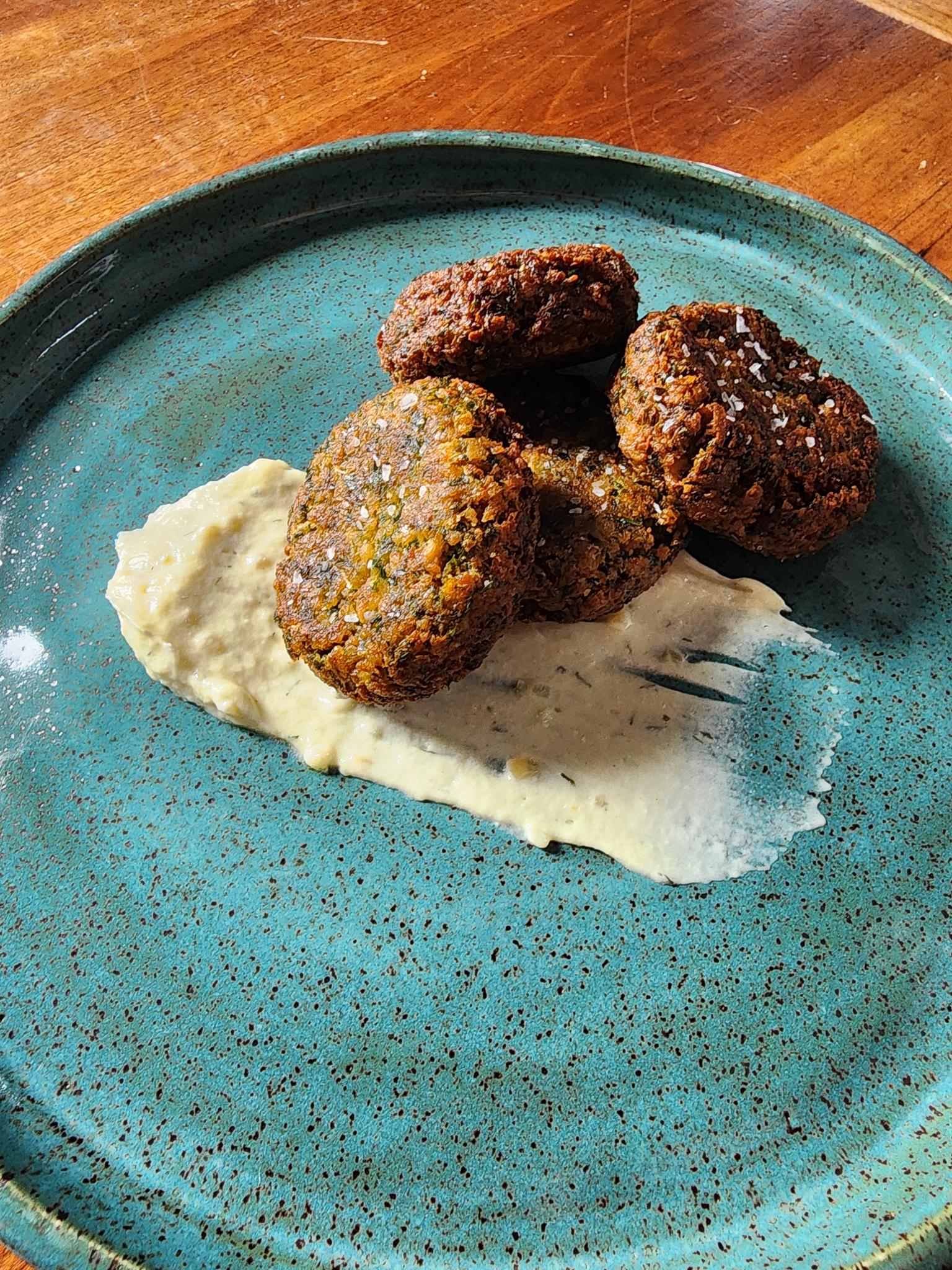 Falafel on a plate with sauce shmear